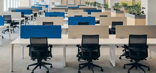Modern open-plan office space featuring clean workstations, ergonomic chairs, and sanitized carpets provided by professional office cleaning services in Long Beach, CA.