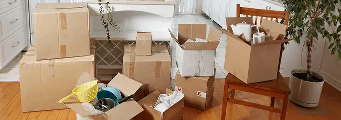 Packed moving boxes and household items in a kitchen before move-out or move-in cleaning, Long Beach, CA.